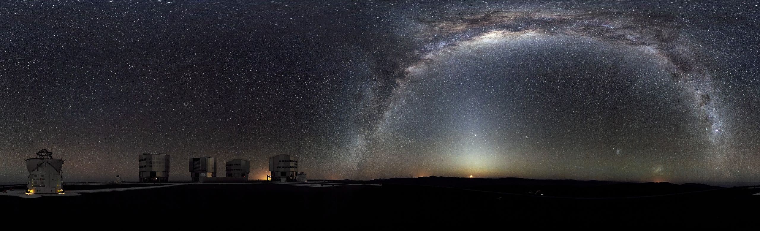 The Milky Way arcs across this 360-degree panorama of the night sky above ESO's Paranal Very Large Telescope.